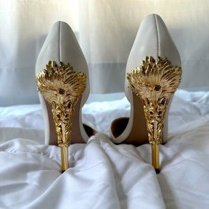 White pumps with gold embellished heels